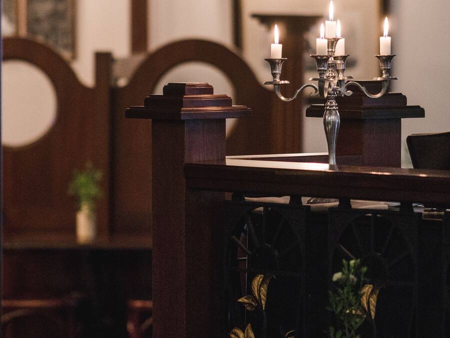 A dining table with a candelabra and a vase of flowers.