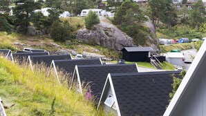 A campsite with multiple tents and RVs, surrounded by trees and rocky terrain. - First Camp City Strömstad (Stromstad)