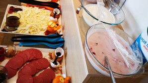 A buffet with various food items including pasta, cheese, meats, and a large bowl of yogurt parfait. - City Hotel Marmaris (Marmaris)