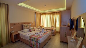 A hotel room with a bed, a desk, a TV, and a mirror. - City Hotel Marmaris (Marmaris)