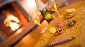 A wooden table with food items and a knife.