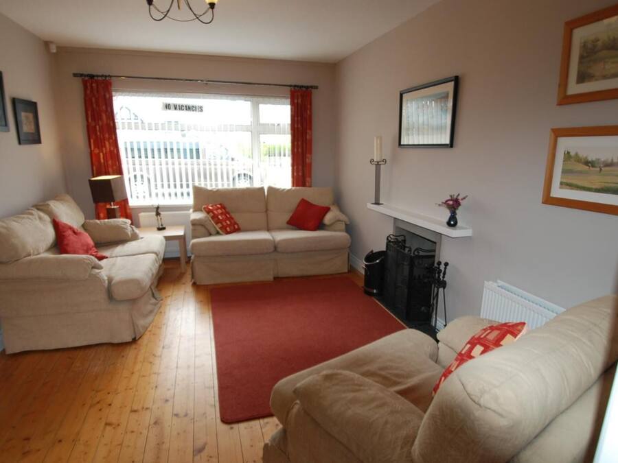 A living room with two sofas, a coffee table, and a fireplace.