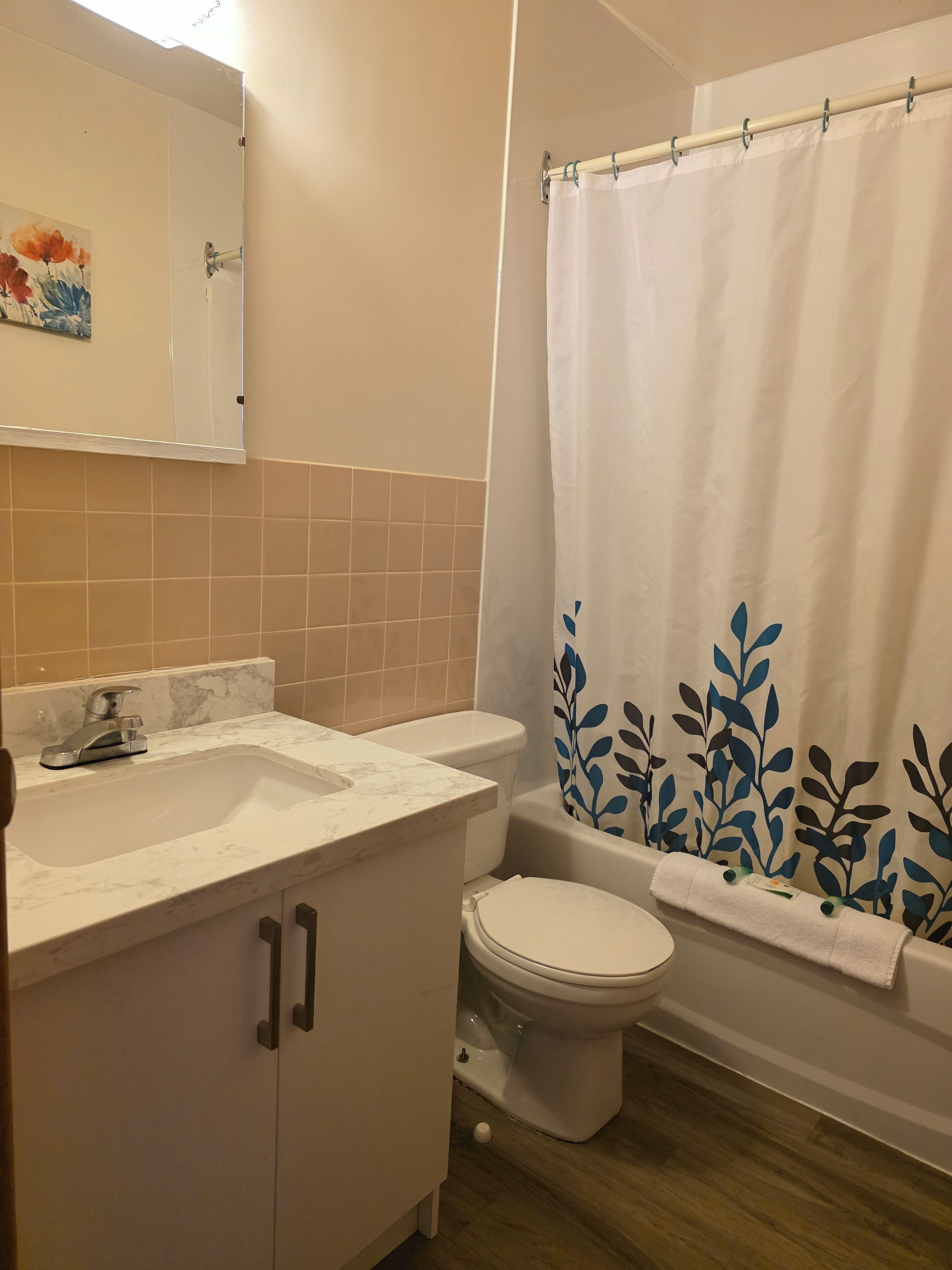 A bathroom with a sink, toilet, and bathtub.