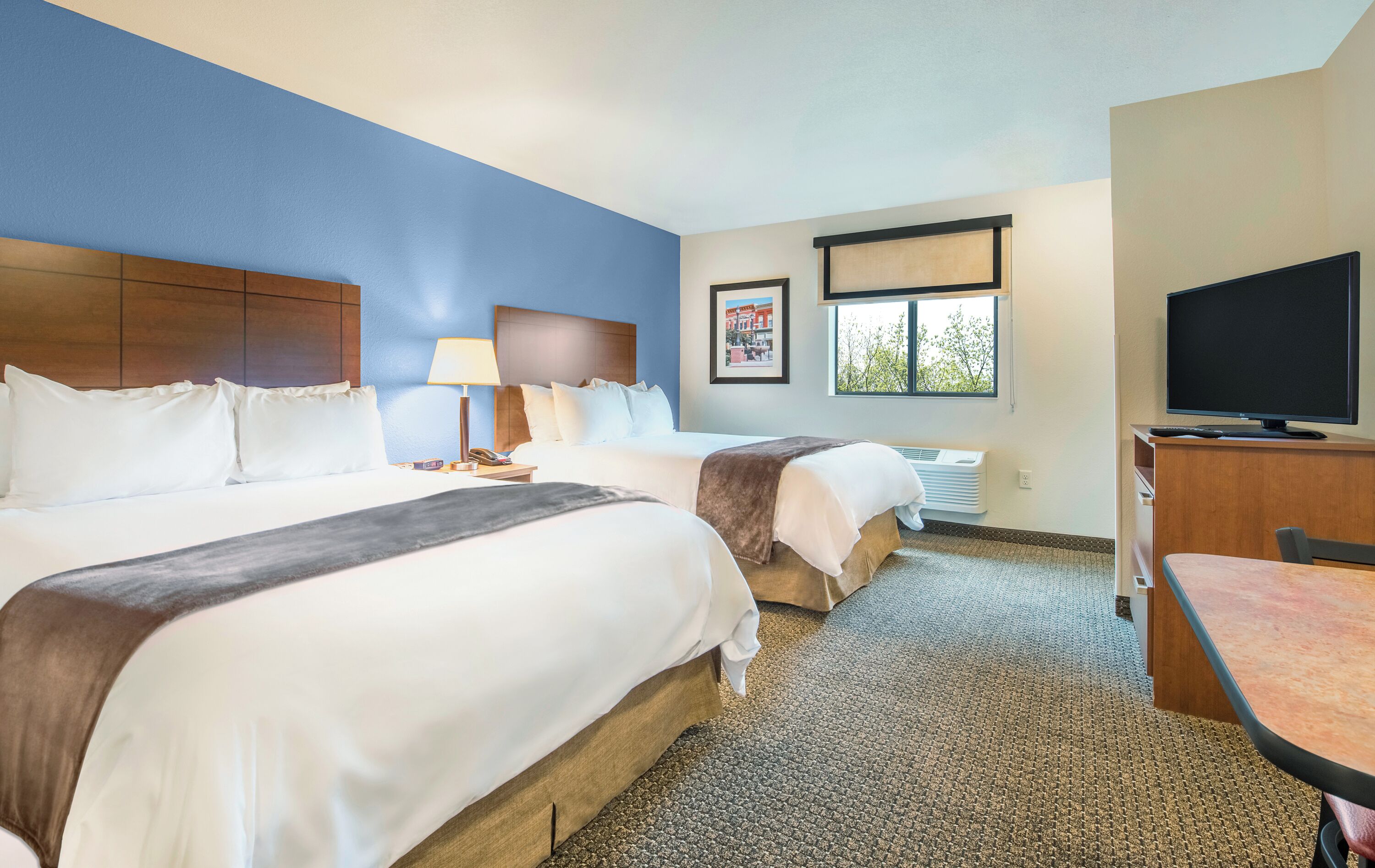 Premium bedding, pillow-top beds, desk, laptop workspace