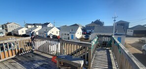 A wooden pier leading to a dock with a boat.