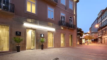 Classic hotel facade with a symmetrical design, featuring multiple windows and a traditional aesthetic.