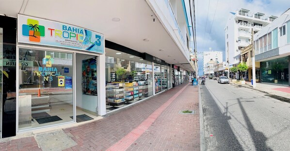A storefront with a sign reading "BAHIA TROPICAL 3" and a visible entrance.