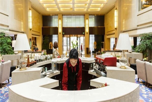 A lobby with a reception desk, seating areas, and large windows. - Hanfu Hotel (Nanjing City)
