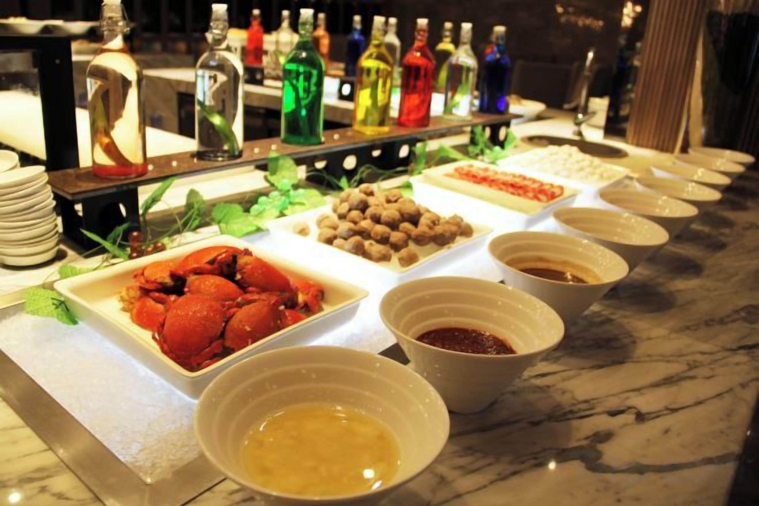 A buffet with various food items and condiments.