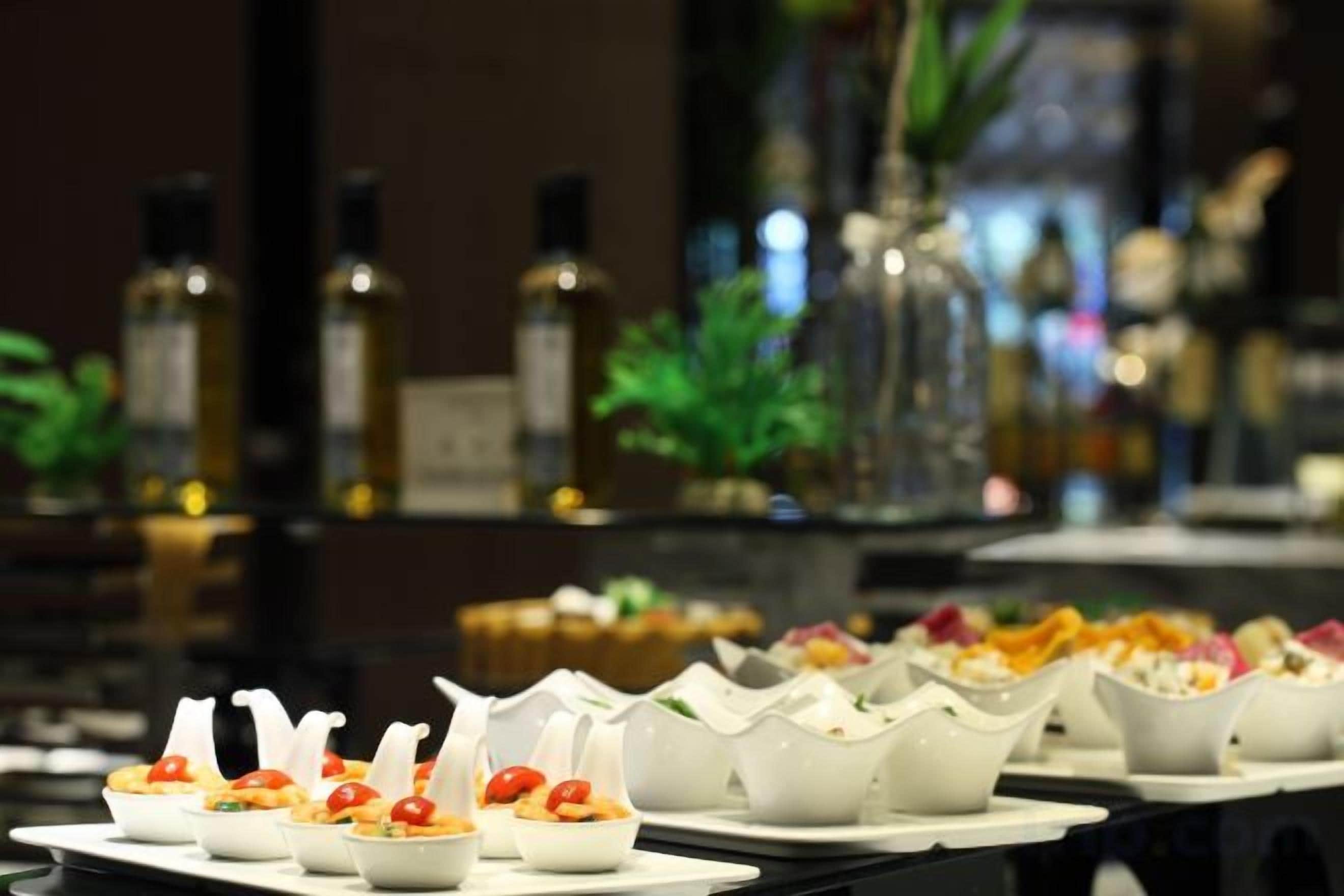 A bar area with bottles and glasses.