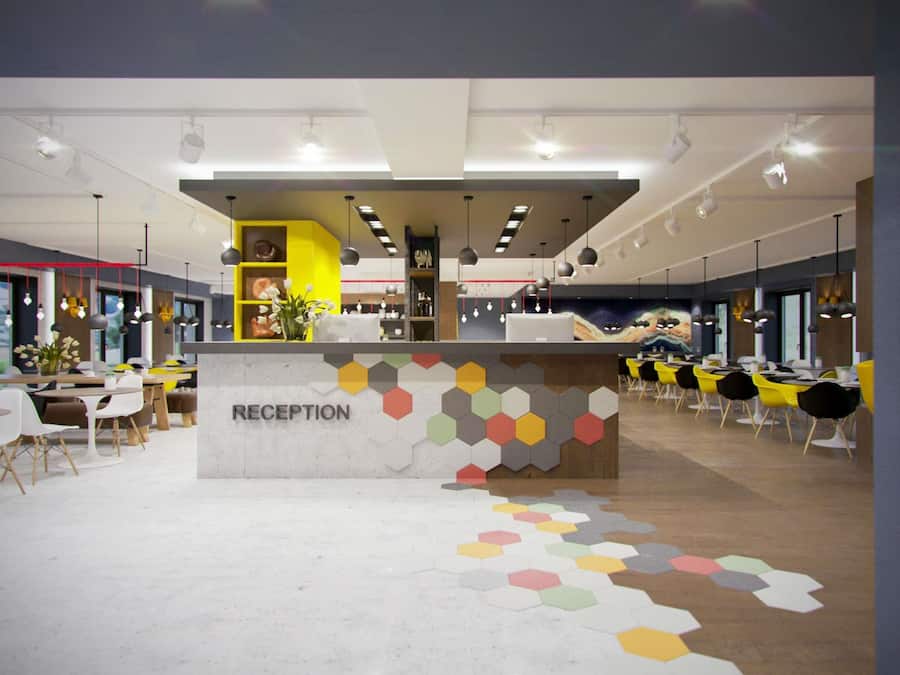 A reception area with a counter, seating, and a colorful hexagonal floor pattern.