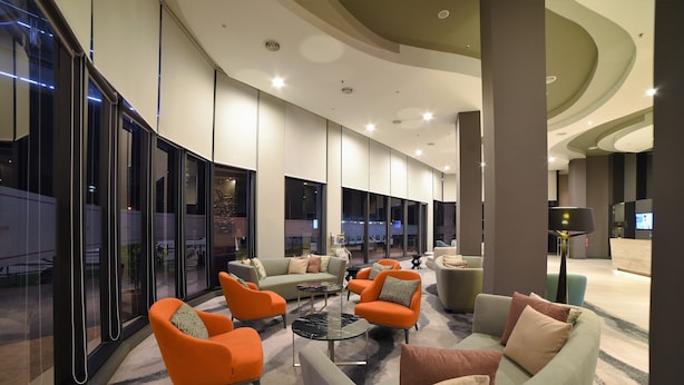A modern lobby with seating areas, large windows, and a central coffee table. - Mercure Selangor Selayang (Batu Caves)