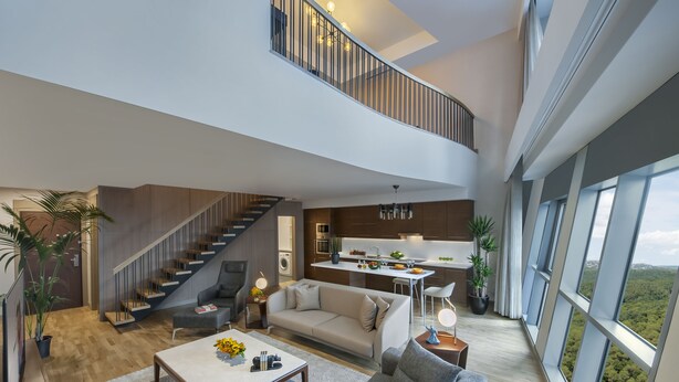 A spacious living area with a staircase leading to a balcony, a kitchen, and large windows offering a view of the landscape. - Somerset Maslak Istanbul (Sariyer)