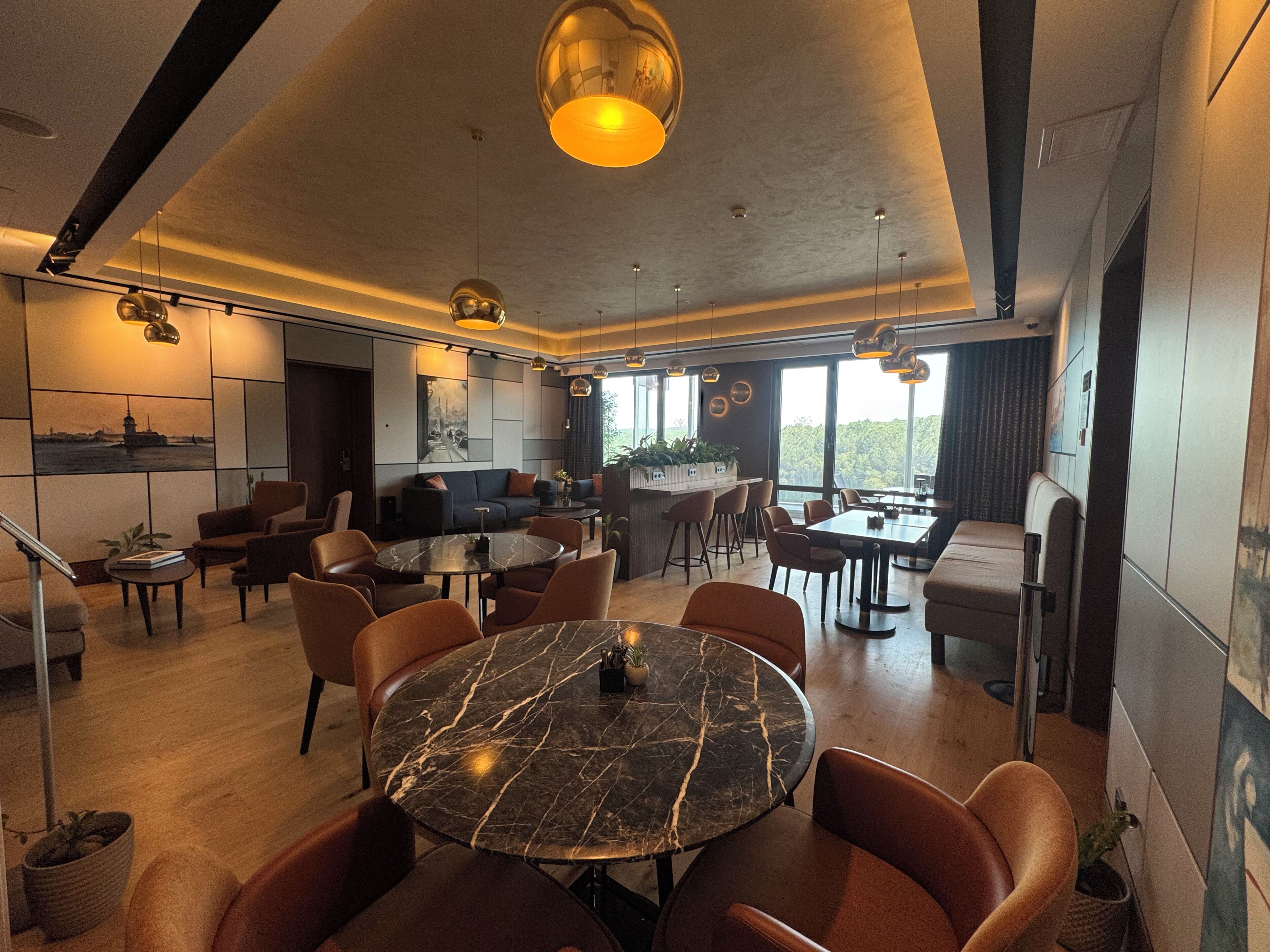 A modern interior with a dining area, seating, and a kitchen.
