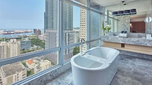 A modern bathroom with a large bathtub, a marble countertop, and a large window offering a city view. - THE AMNIS, a Luxury Collection Hotel, Kaohsiung (Kaohsiung)