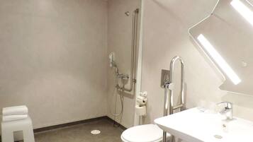 A modern bathroom with a toilet, sink, and shower.