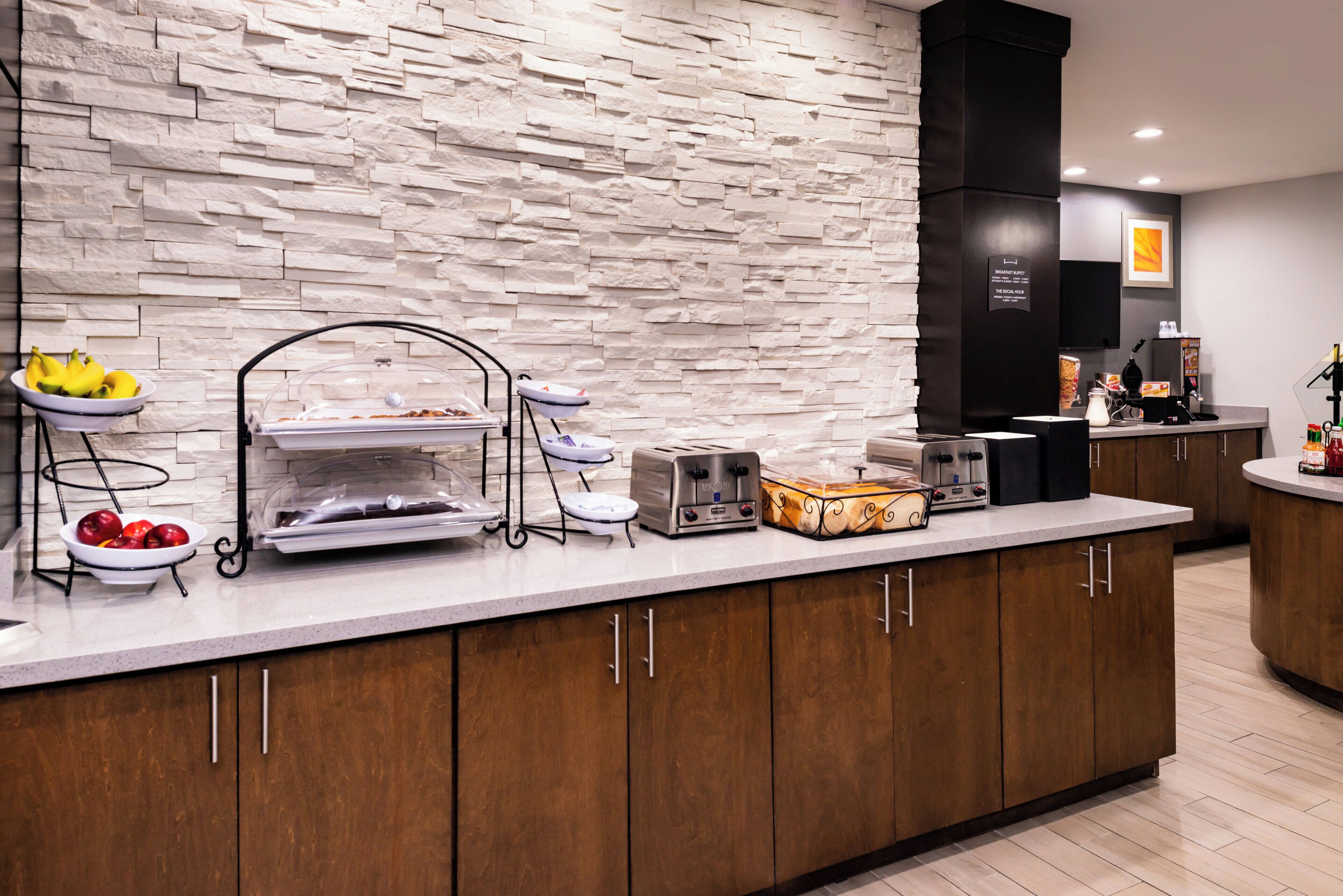A breakfast buffet setup with various food items and a toaster.