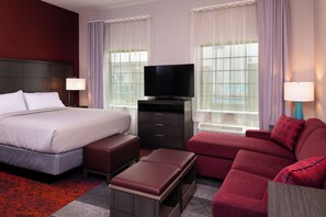 A hotel room with a large bed, a TV, a sofa, and a desk. - Staybridge Suites Lake Charles by IHG (Lake Charles)
