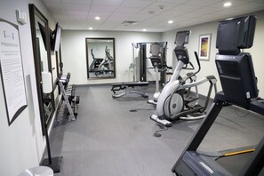 A fitness room with treadmills, weight machines, and a mirror. - Staybridge Suites Lake Charles by IHG (Lake Charles)