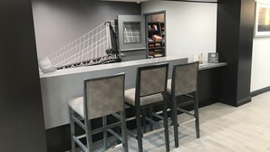 A modern kitchen with a built-in island, grey cabinetry, and a non-smoking sign.