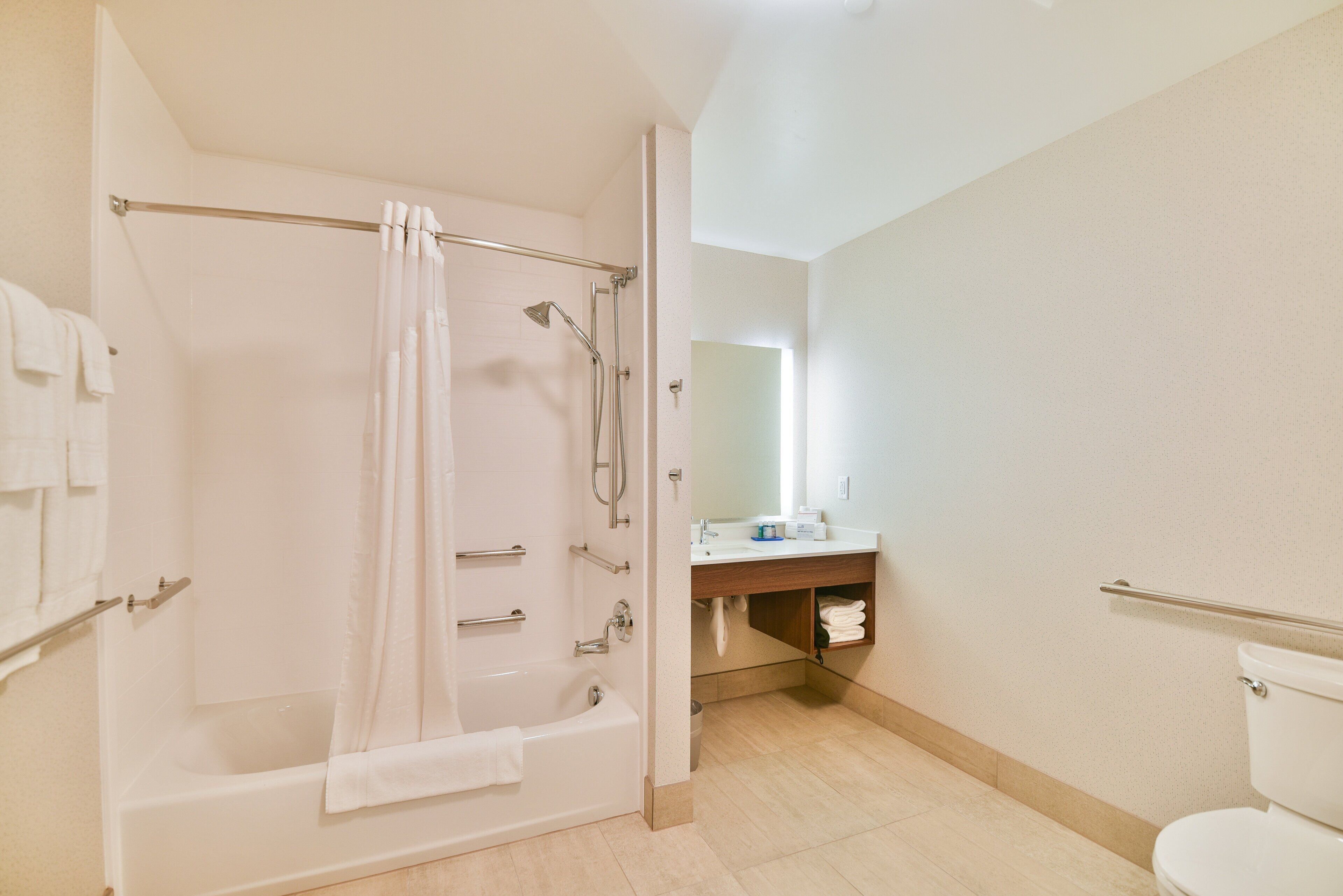 A bathroom with a bathtub, toilet, and sink.