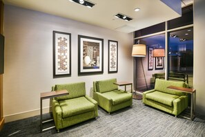 A hotel lobby with three green armchairs, a small table, and framed artwork on the wall. - Holiday Inn Express and Suites-Lehi - Thanksgiving Point by IHG (Lehi)