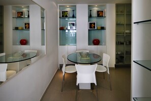 Enjoy dining and socializing in this stylish space with a round table and comfortable seating for four.