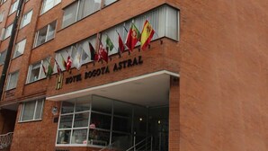 A multi-story hotel with a brick facade and a sign reading "Hotel Bogota Astral". - Hotel Bogota Astral (Bogotá)