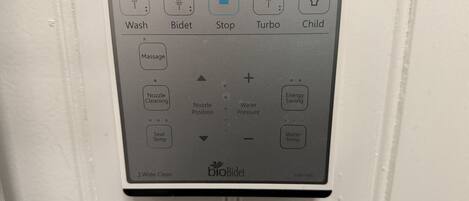 A control panel with options like Wash, Bidet, Stop, Turbo, and Child.