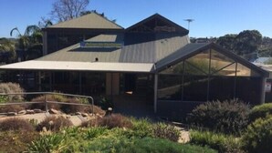 A modern building with a large glass extension, a sign reading "Hoblenuse Outdoor Markets," and a metal roof. - McLaren Vale Backpackers (McLaren Vale)