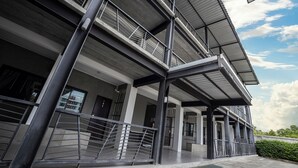 A multi-story building with a modern architectural design, featuring balconies and a covered walkway. - B2 Lanna Boutique & Budget Hotel (Chiang Mai)