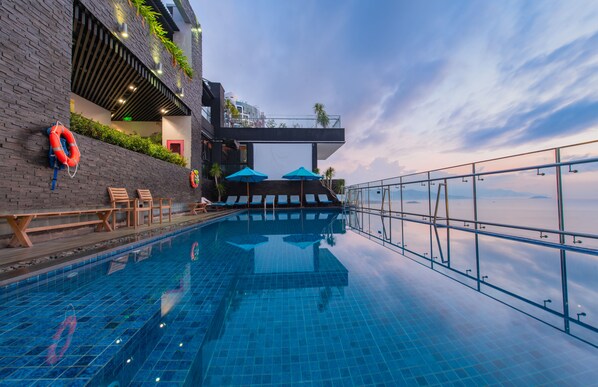 Outdoor pool, open 7:00 AM to 7:00 PM, pool umbrellas, sun loungers