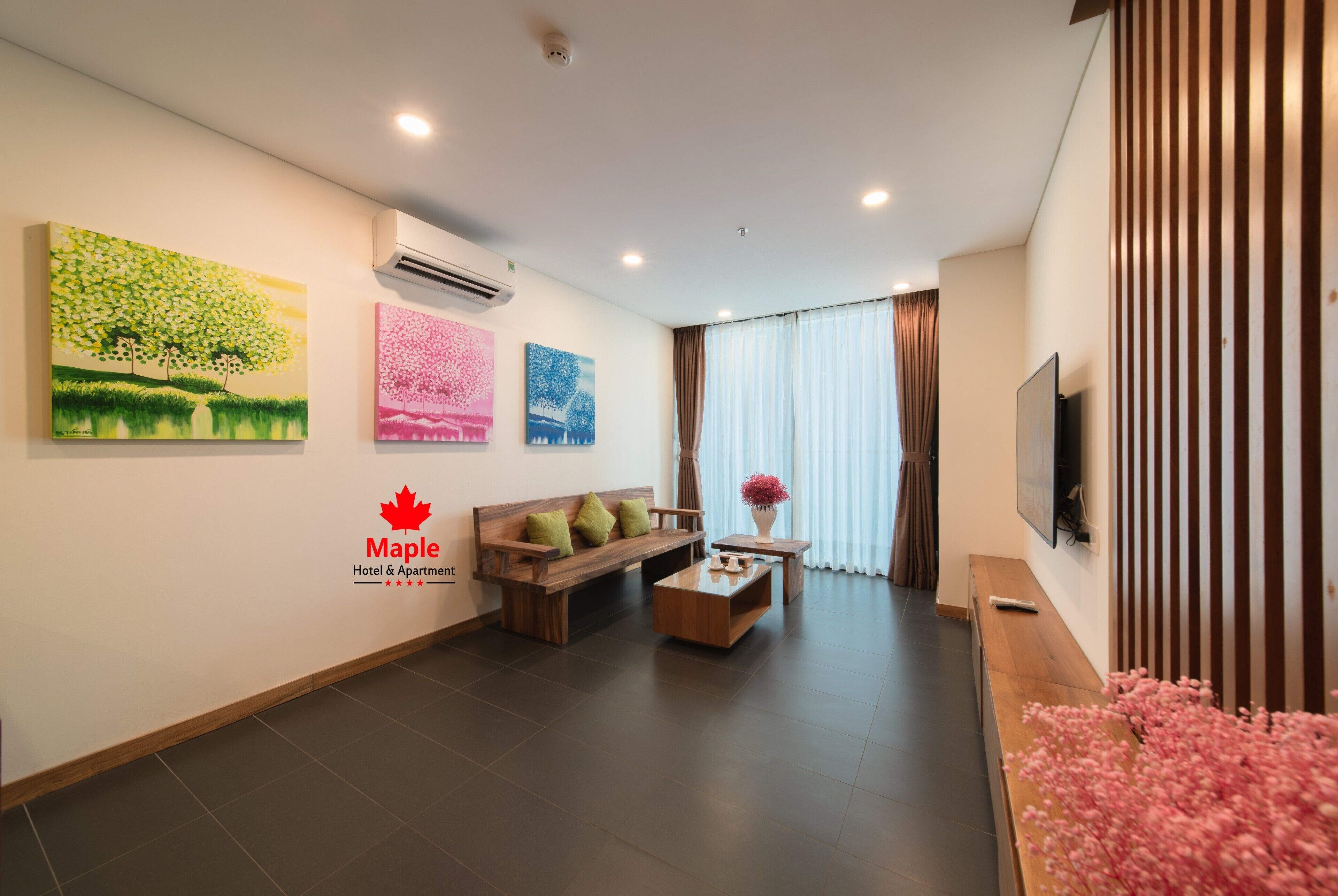 A hotel lobby with a wooden bench, a coffee table, and artwork on the walls.