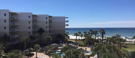 A resort with a pool, beach, and ocean view.