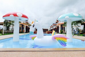 A swimming pool with inflatable swan and mushroom decorations. - Infinity See Sun Resort (Krasang)