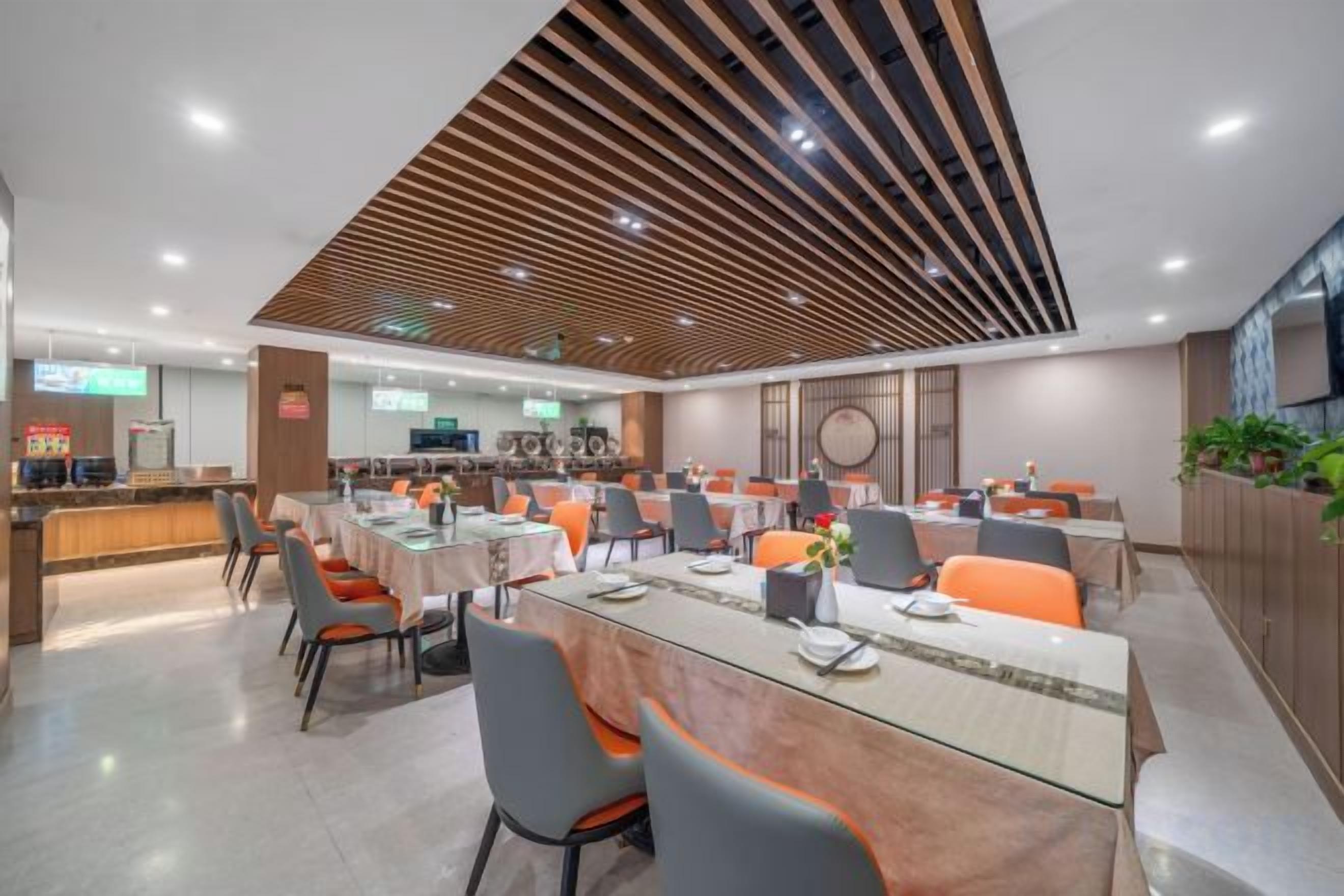 A modern dining area with a central table, multiple chairs, and a counter with a cash register.