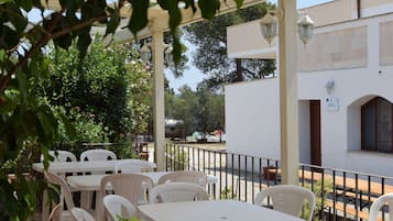 Relax in a shaded patio area with comfortable seating and a scenic view.