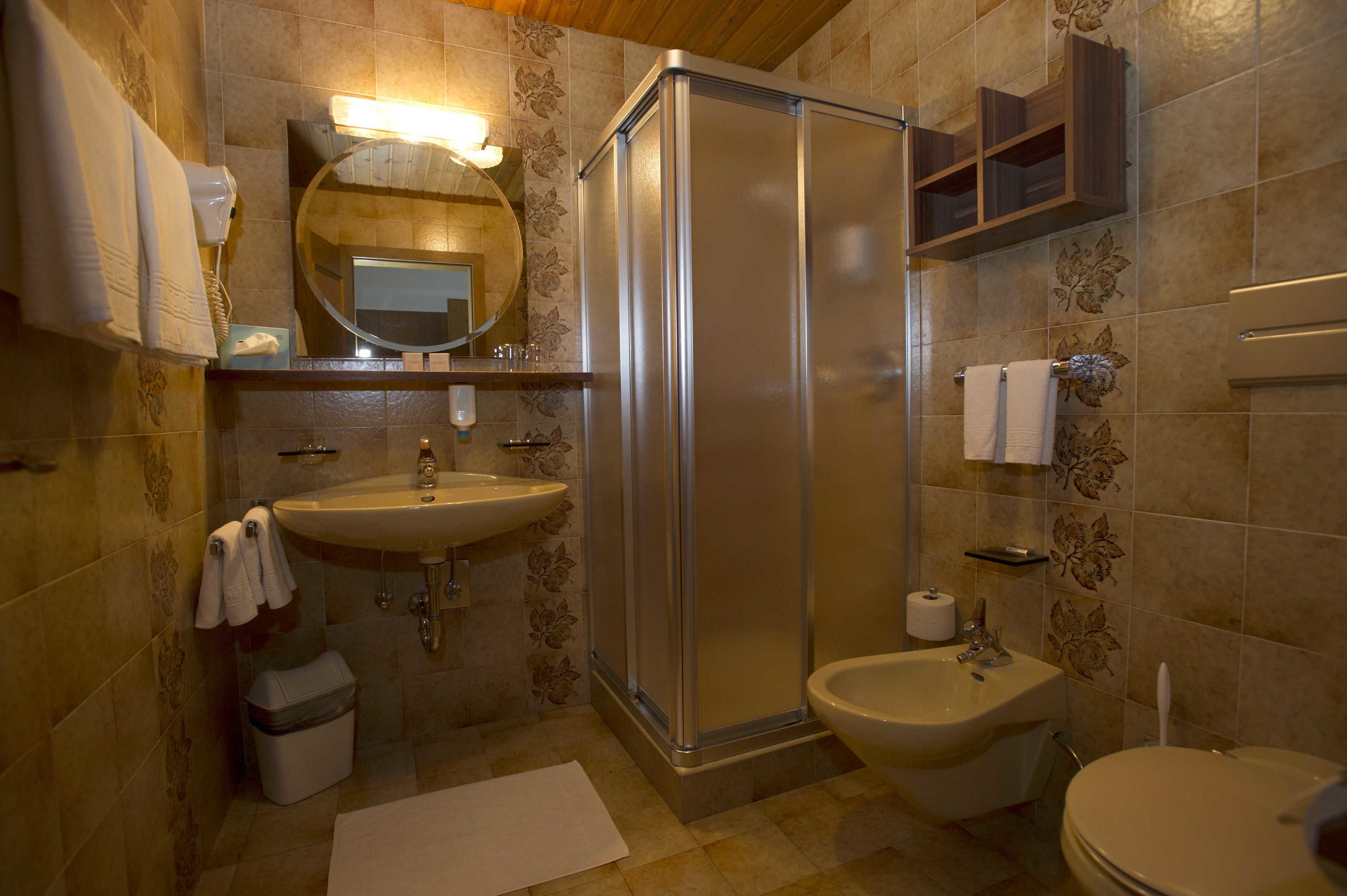 A bathroom with a sink, toilet, and shower.