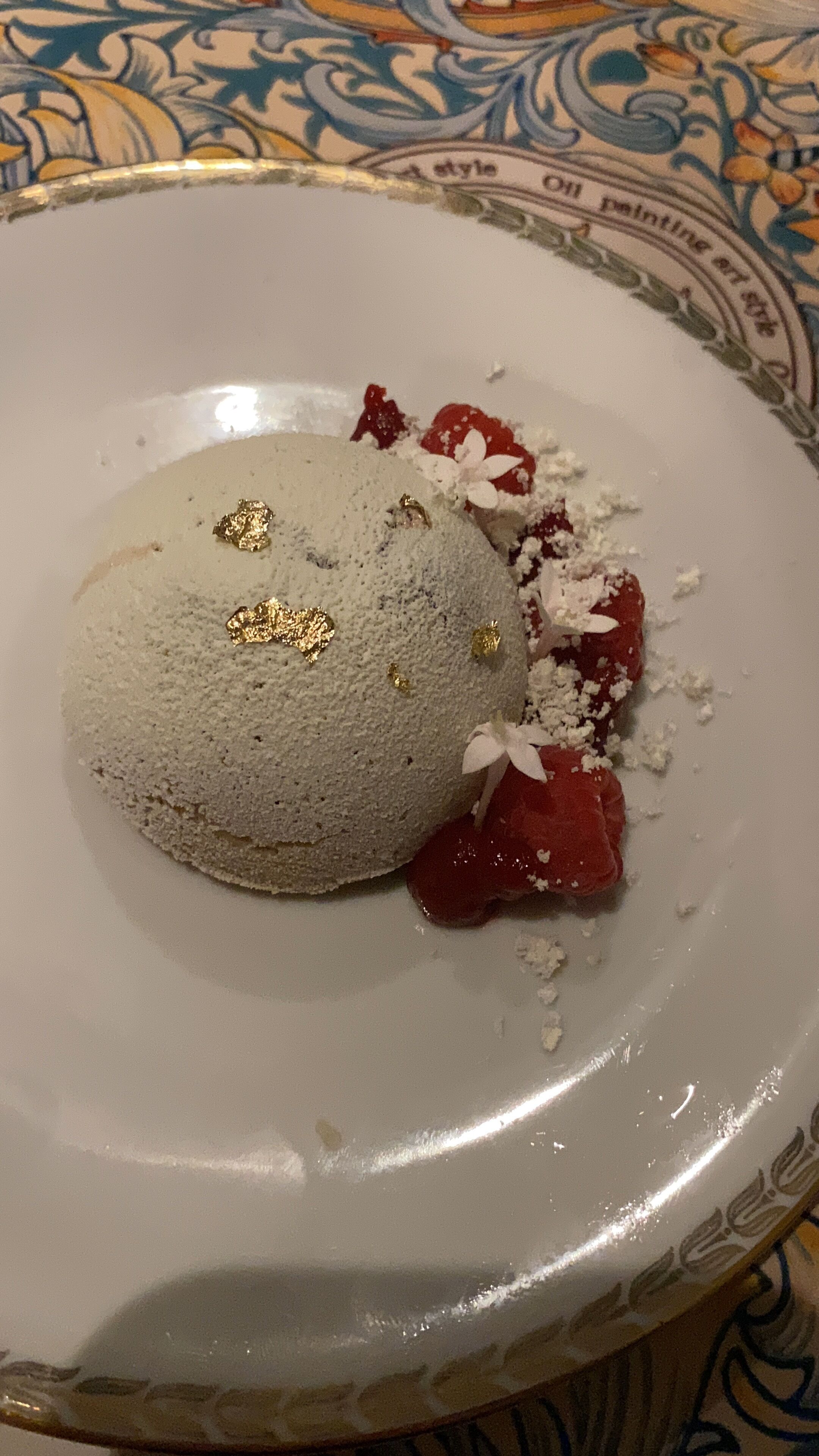 A dessert on a plate with a patterned tablecloth.