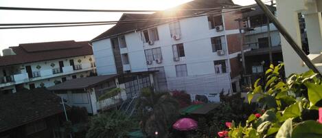 A multi-story building with balconies and air conditioning units.
