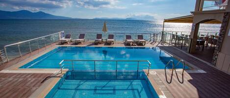 Outdoor pool, pool umbrellas, sun loungers