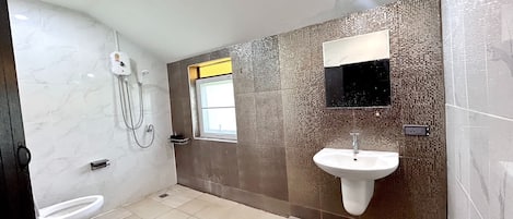 A bathroom with a toilet, a sink, and a shower.