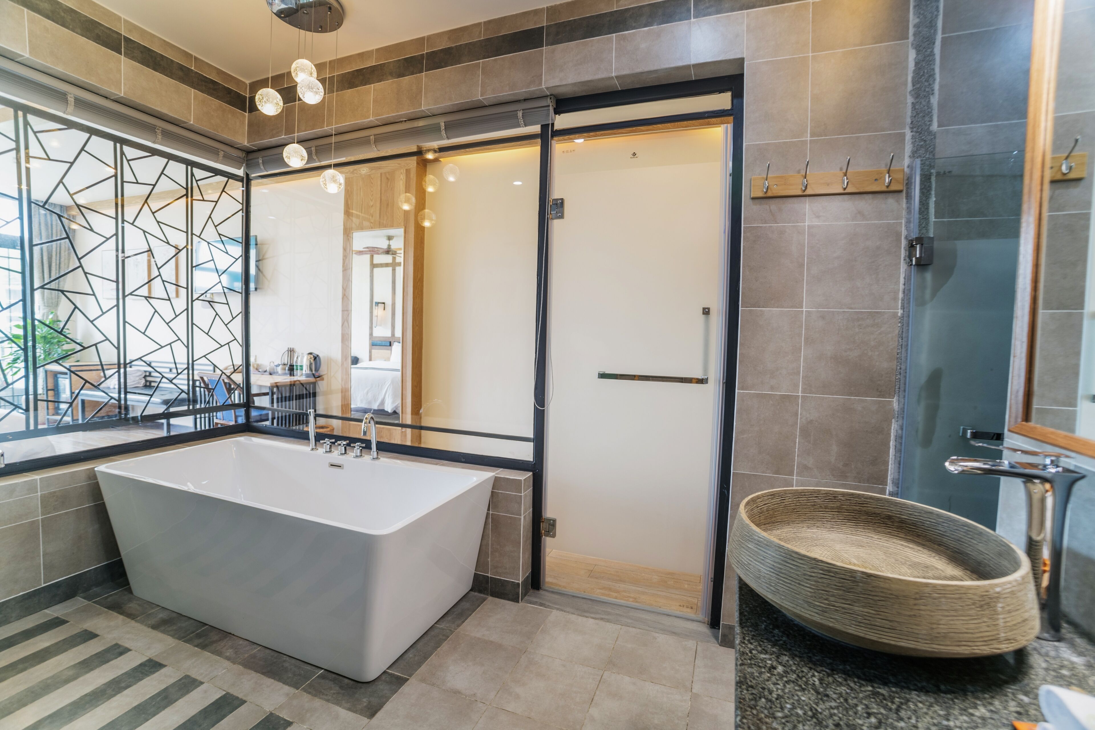 A modern bathroom with a freestanding bathtub, a glass shower enclosure, and a large mirror.