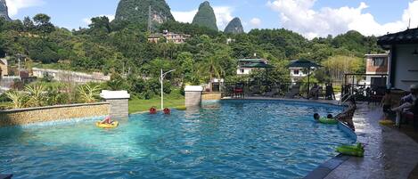 Outdoor pool, open 9:30 AM to 9:00 PM, pool umbrellas, pool loungers