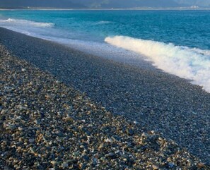 A pebbled beach with waves crashing onto the shore. - Spring Garden (Hualien City)