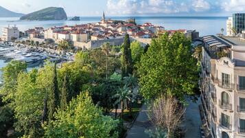 A coastal town with historic buildings, a marina, and a prominent church.