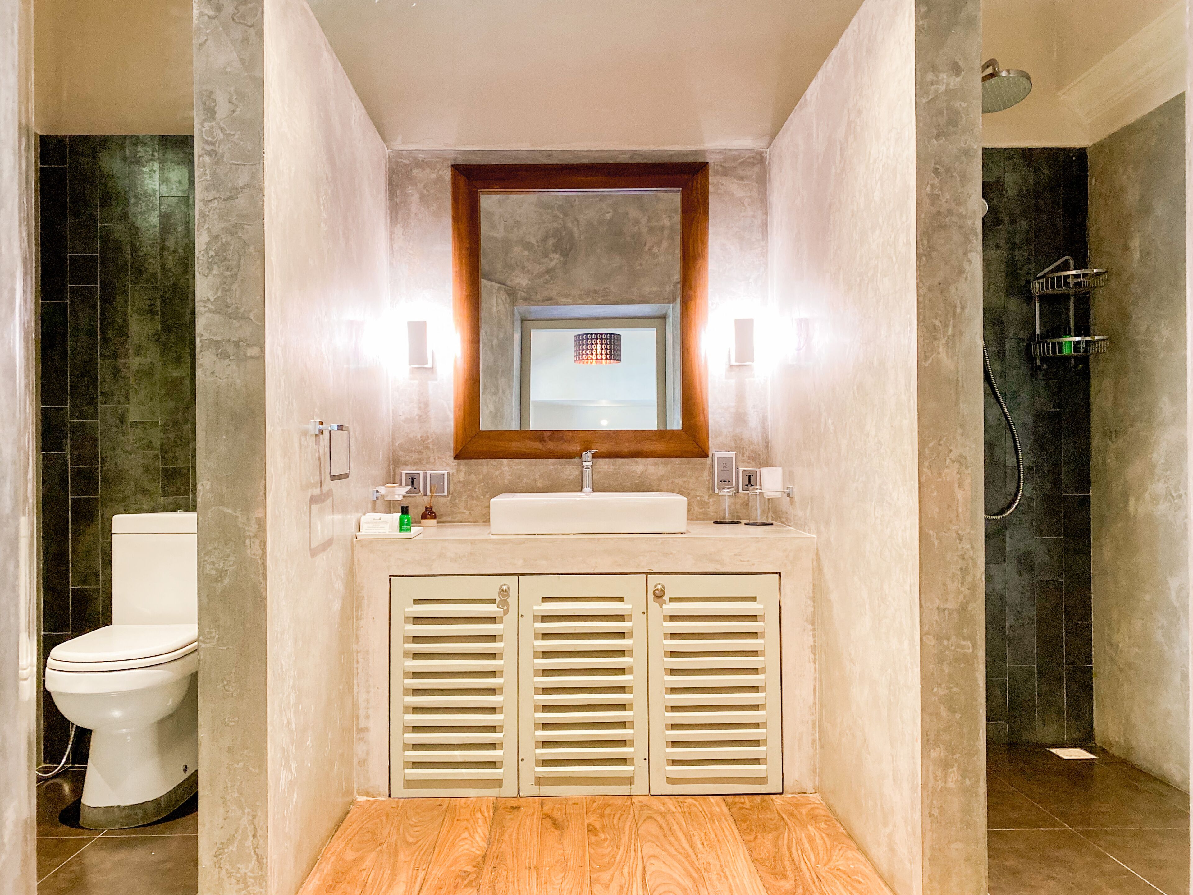 A modern bathroom with a toilet, sink, and shower.