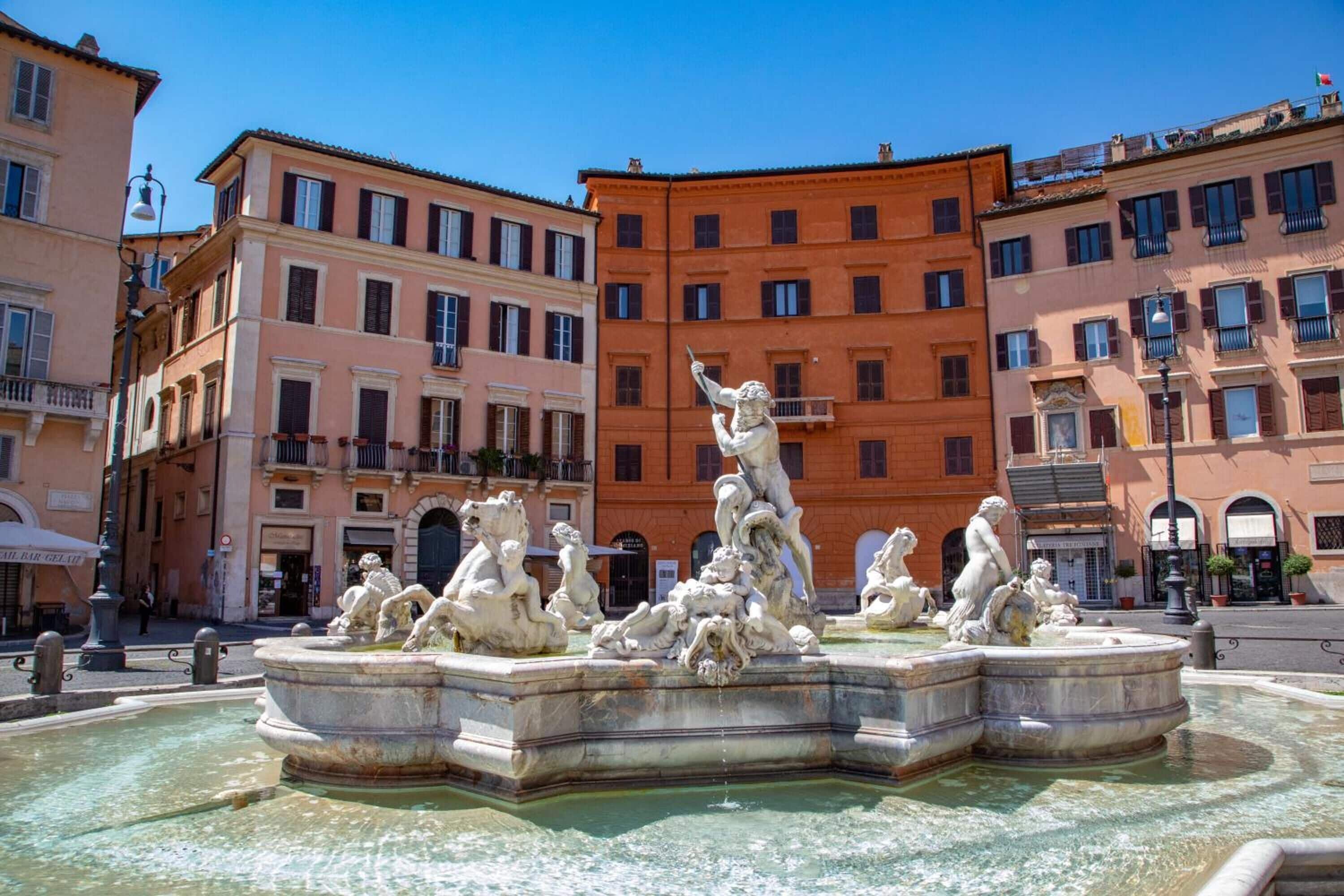 Una fontana neoclassica con diverse statue in una piazza circondata da edifici storici.