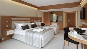 A modern hotel room with a large bed, a bedside table, a chair, and a desk with a laptop and a cup. - Kaçkar Resort Hotel (Camlihemsin)