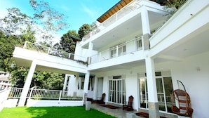 A two-story building with a covered patio, large windows, and a balcony with railings. - Sunlit Villa (Harispattuwa)